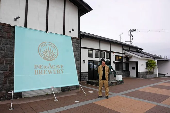 Shuhei Okazumi stands in front of Ine to Agave Brewery in Akita