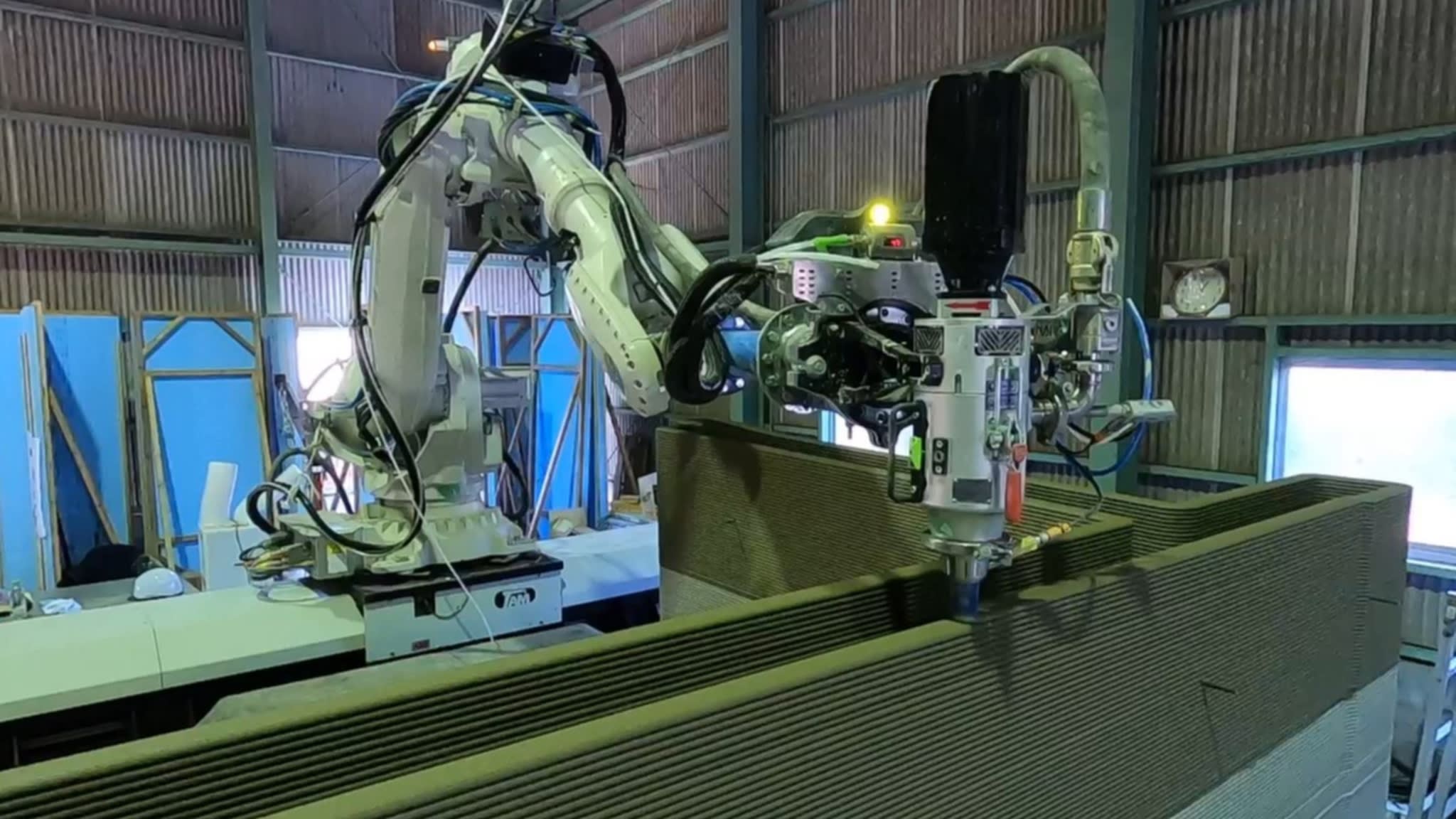 A 3D concrete printer is used to construct a wall at a Serendix plant