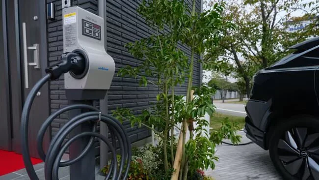 A Nichicon model house features a V2H system