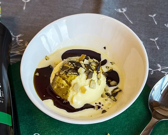 Vanilla ice cream parfait sprinkled with pumpkin seed oil and roasted pumpkin seeds