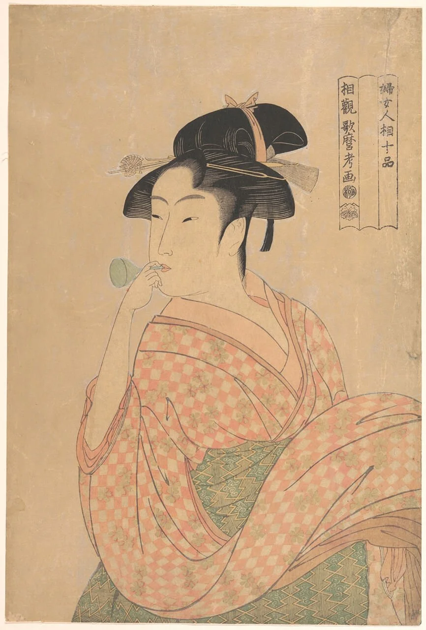 Young woman blowing a popen
